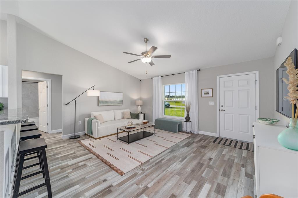 3103 Southwest 130th Lane Ocala, FL 34473 - Photo 6 of 31 a living room with furniture and a wooden floor