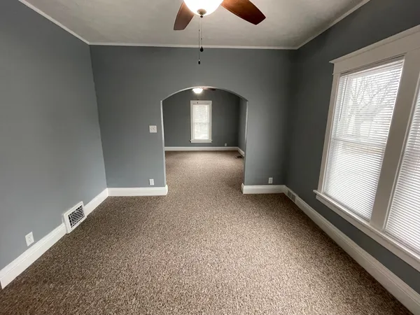 an empty room with a empty space and a window