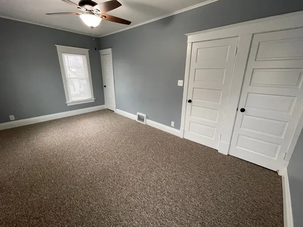 a view of an empty room with a window