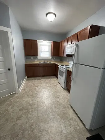 a kitchen with refrigerator and window