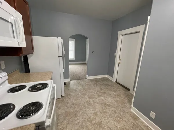 a kitchen with a refrigerator and a stove