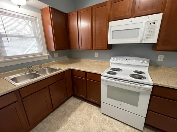 a kitchen with a sink stove and microwave