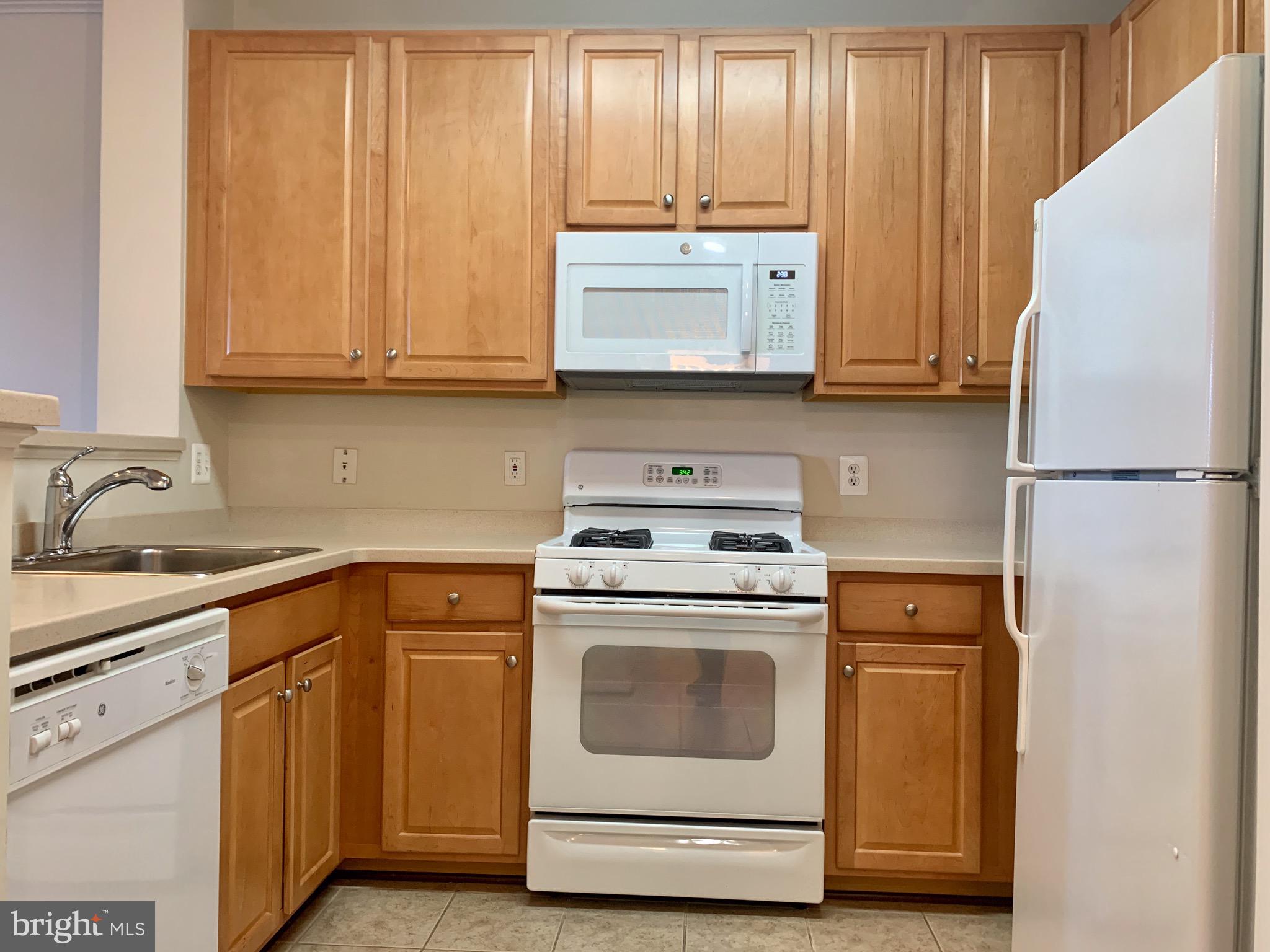 12001 Market Street, Unit 261 Reston, VA 20190 - Photo 5 of 24 maple cabinet, Corian countertop, new microwave