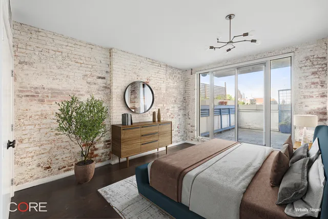 a bedroom with a bed mirror and a window