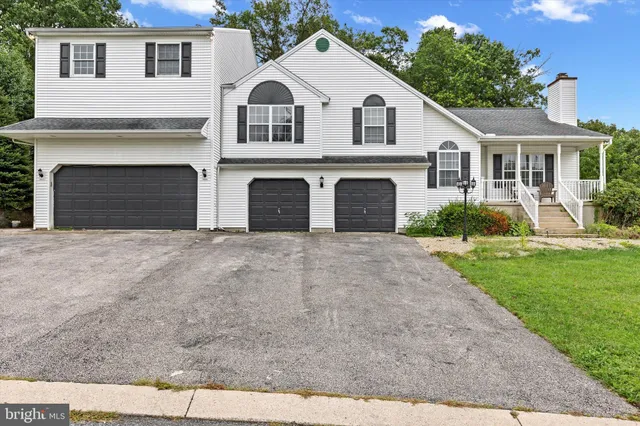 a view of a white house with a yard