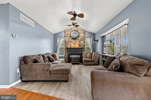 a living room with furniture chandelier and a window