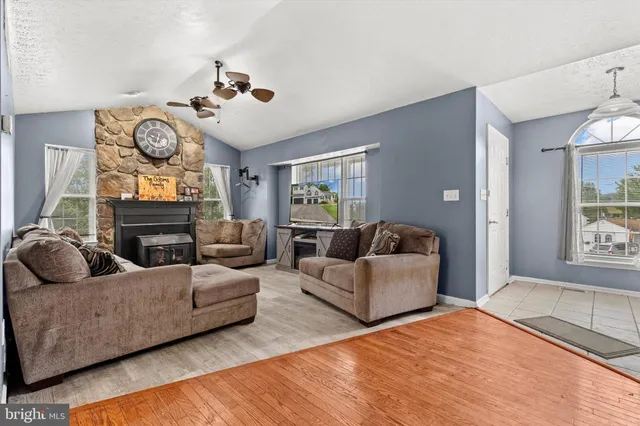 a living room with fireplace furniture and a window