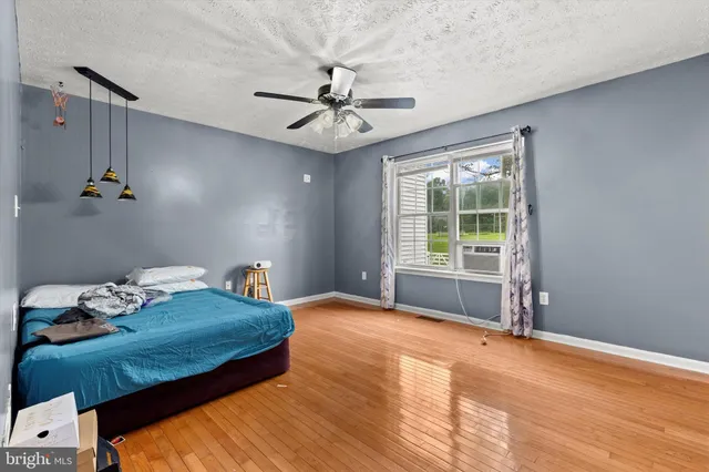 a view of an empty room and wooden floor