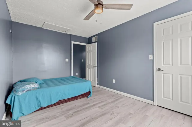 a bathroom with a granite countertop sink toilet a mirror and shower