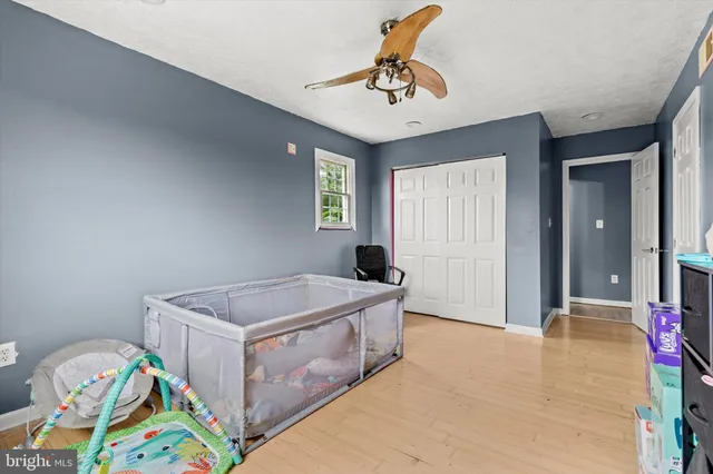 a spacious bedroom with a bed and a chandelier