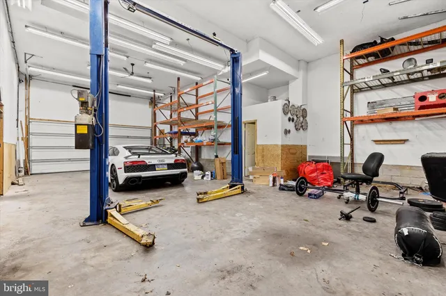 a view of a house with barbeque and wooden stairs