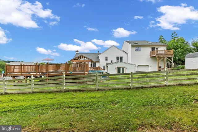 a view of a big house with a big yard and potted plants