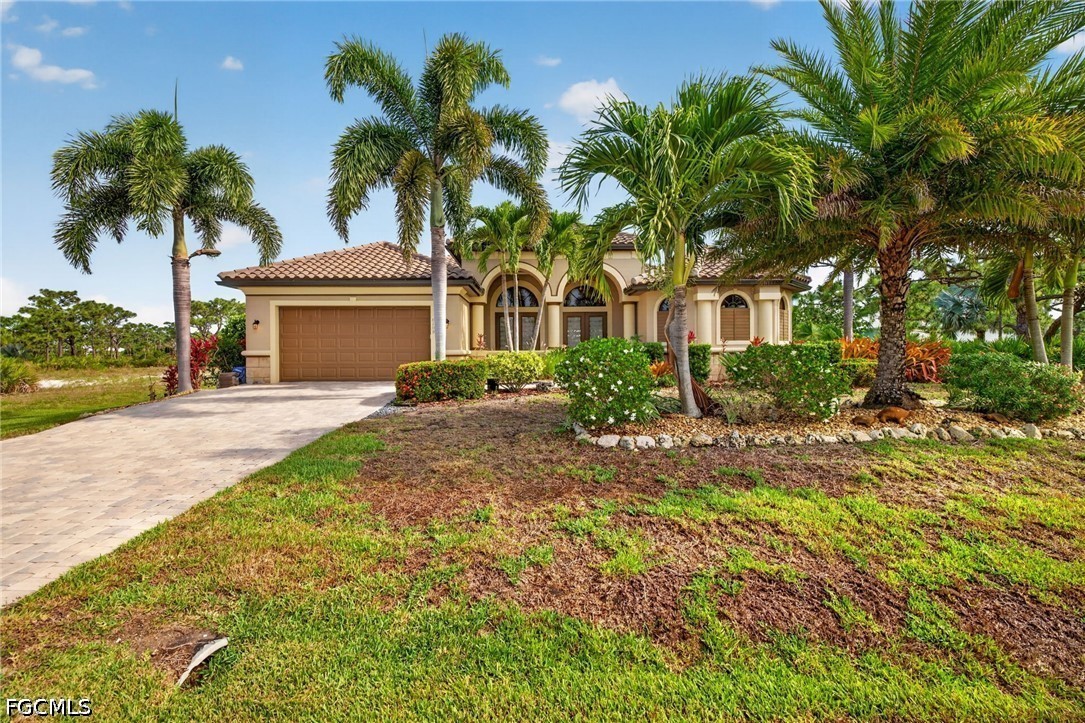 6109 Calusa Rdg Trail Bokeelia, FL 33922 - Photo 7 of 48 a front view of a house with yard and green space