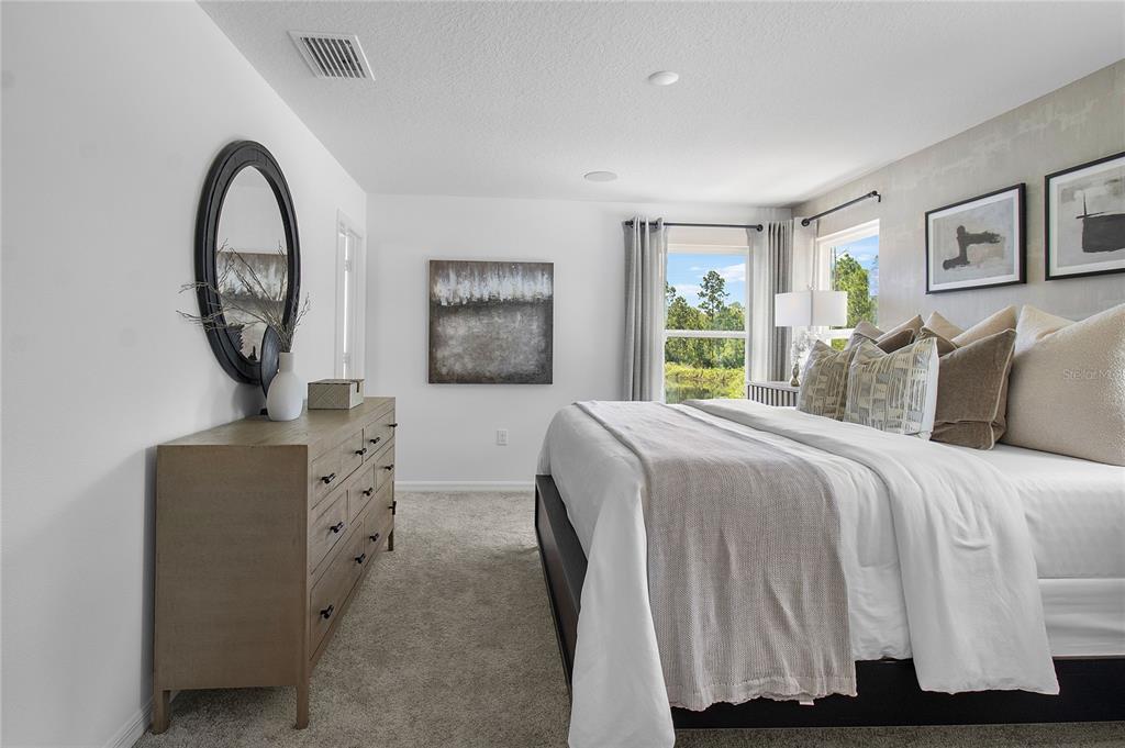 16639 Luminary Loop Clermont, FL 34714 - Photo 20 of 26 a bedroom with a bed and a dresser
