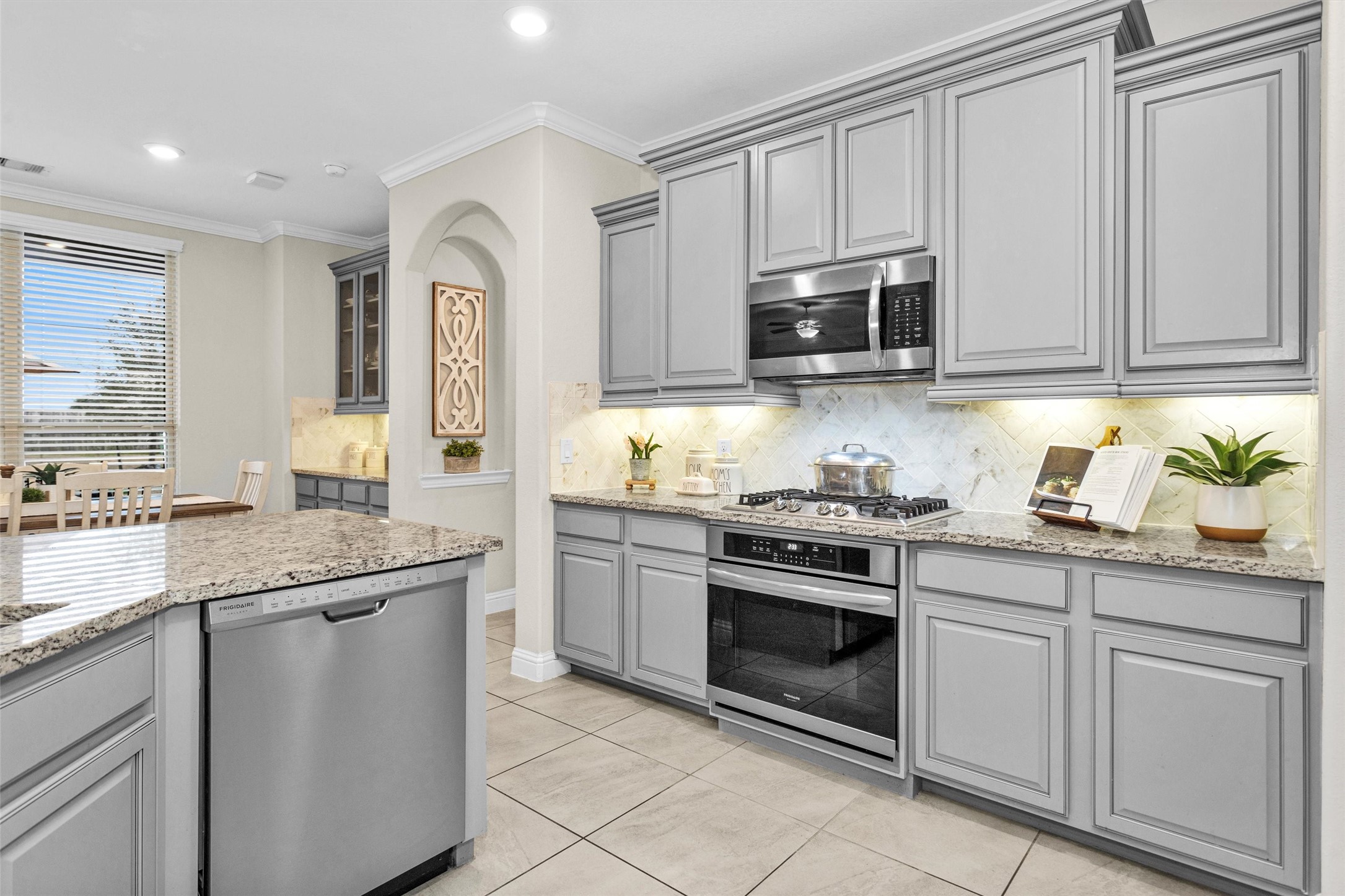 3622 Lister Drive Rosharon, TX 77583 - Photo 16 of 44 a kitchen with granite countertop white cabinets stainless steel appliances and a sink