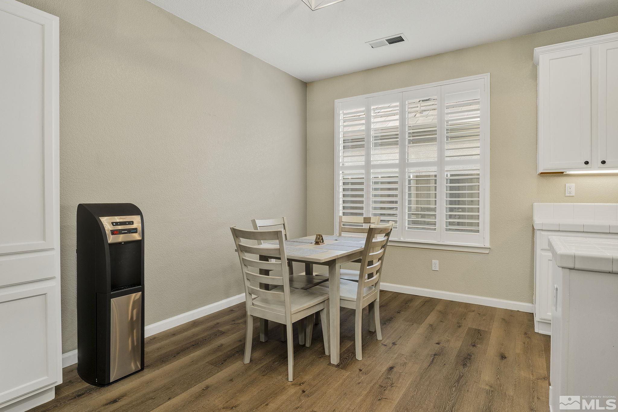 495 Dartmoor Court Reno, NV 89521 - Photo 11 of 22 a view of a dining room with furniture and wooden floor
