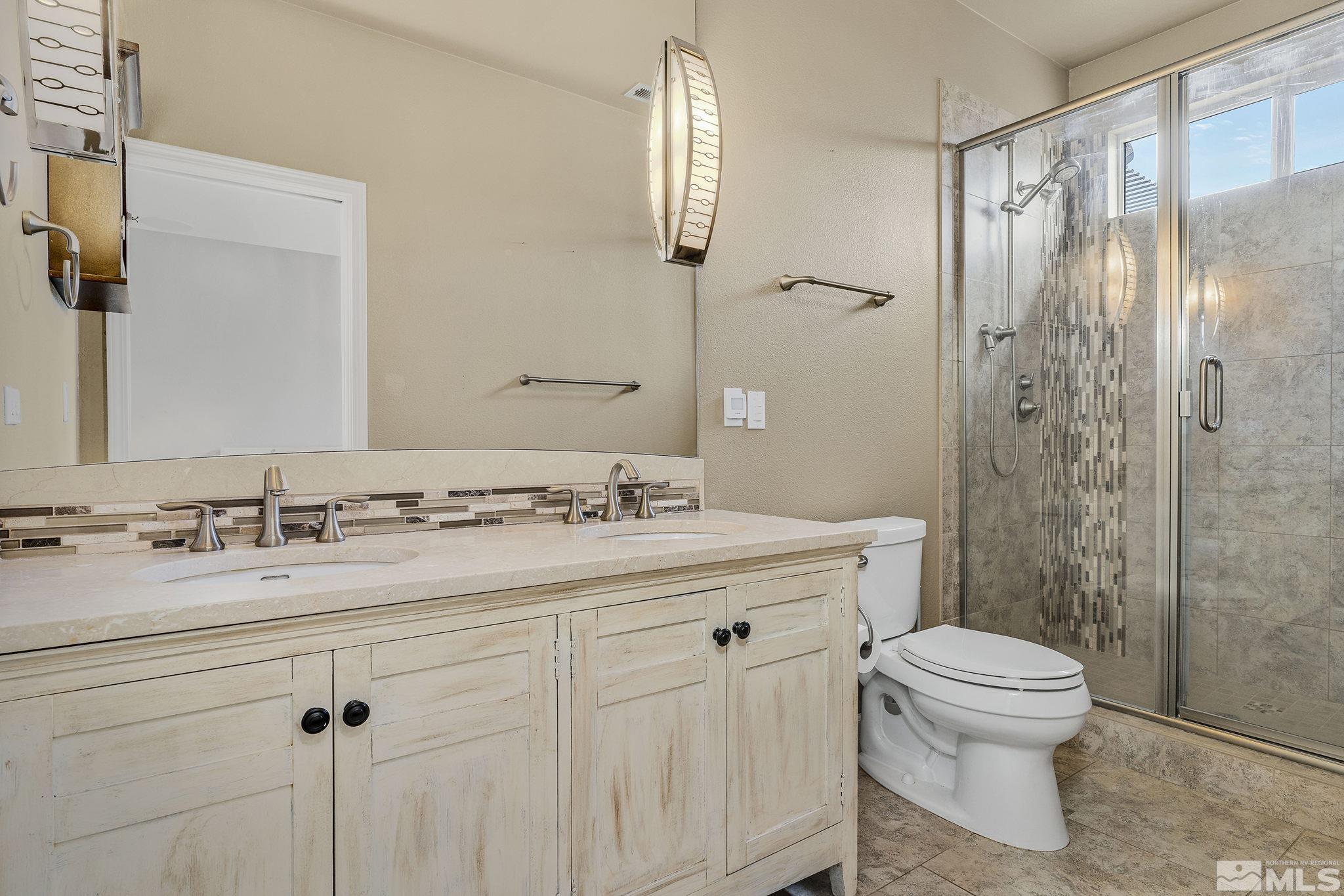 495 Dartmoor Court Reno, NV 89521 - Photo 14 of 22 a bathroom with a sink a toilet and shower