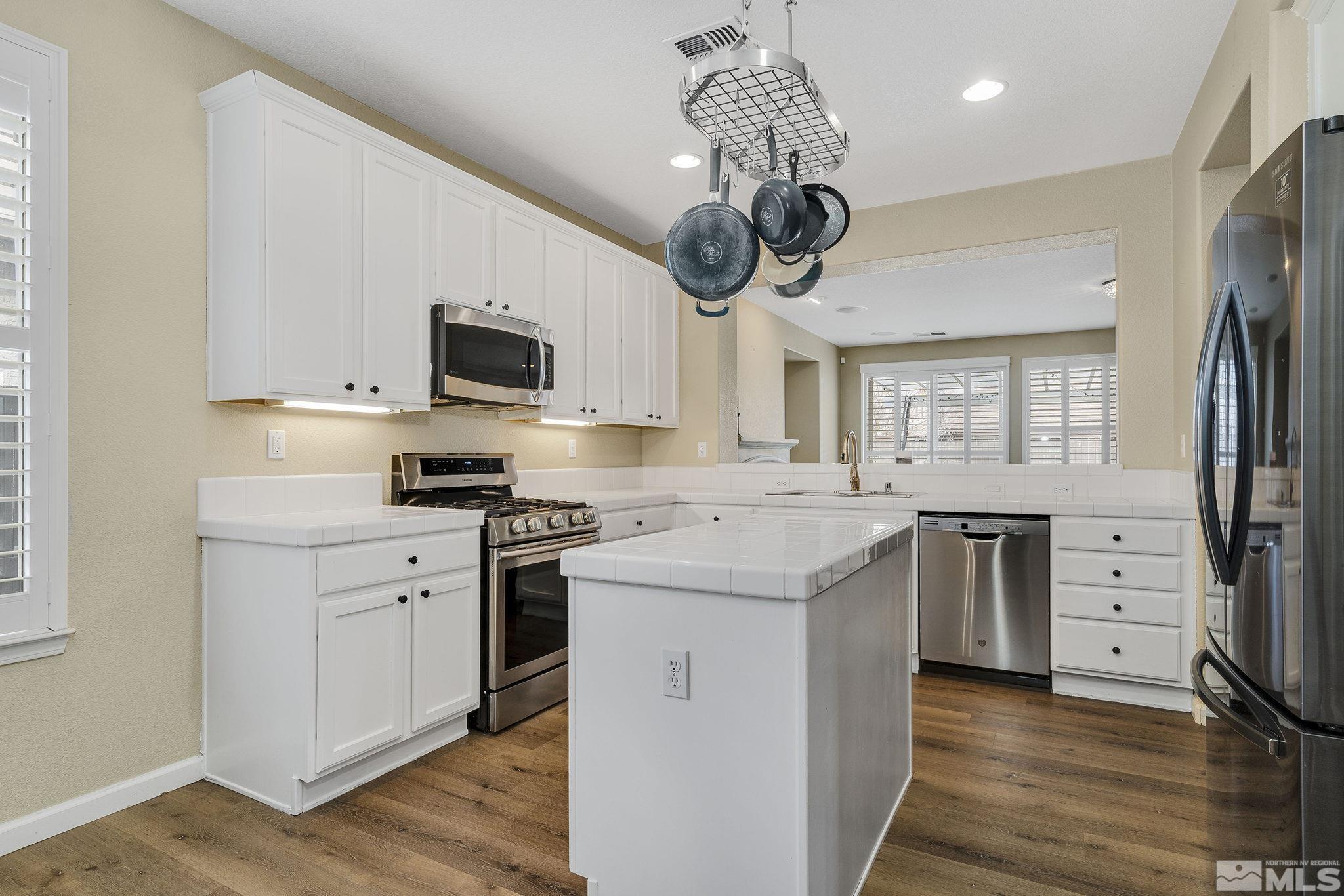 495 Dartmoor Court Reno, NV 89521 - Photo 8 of 22 a kitchen with a stove a sink and a refrigerator