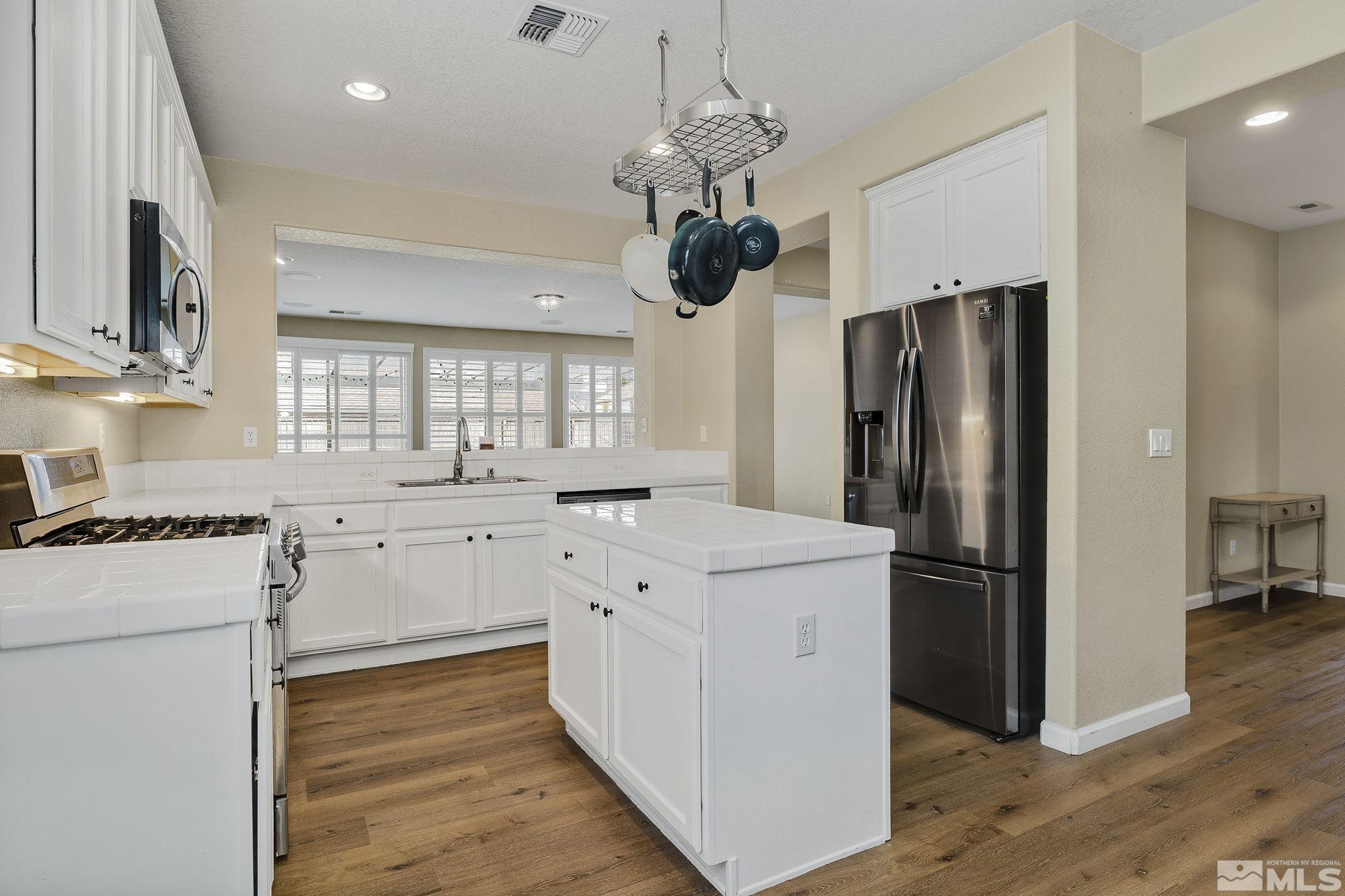 495 Dartmoor Court Reno, NV 89521 - Photo 9 of 22 a kitchen with stainless steel appliances granite countertop a refrigerator a stove a sink and a refrigerator