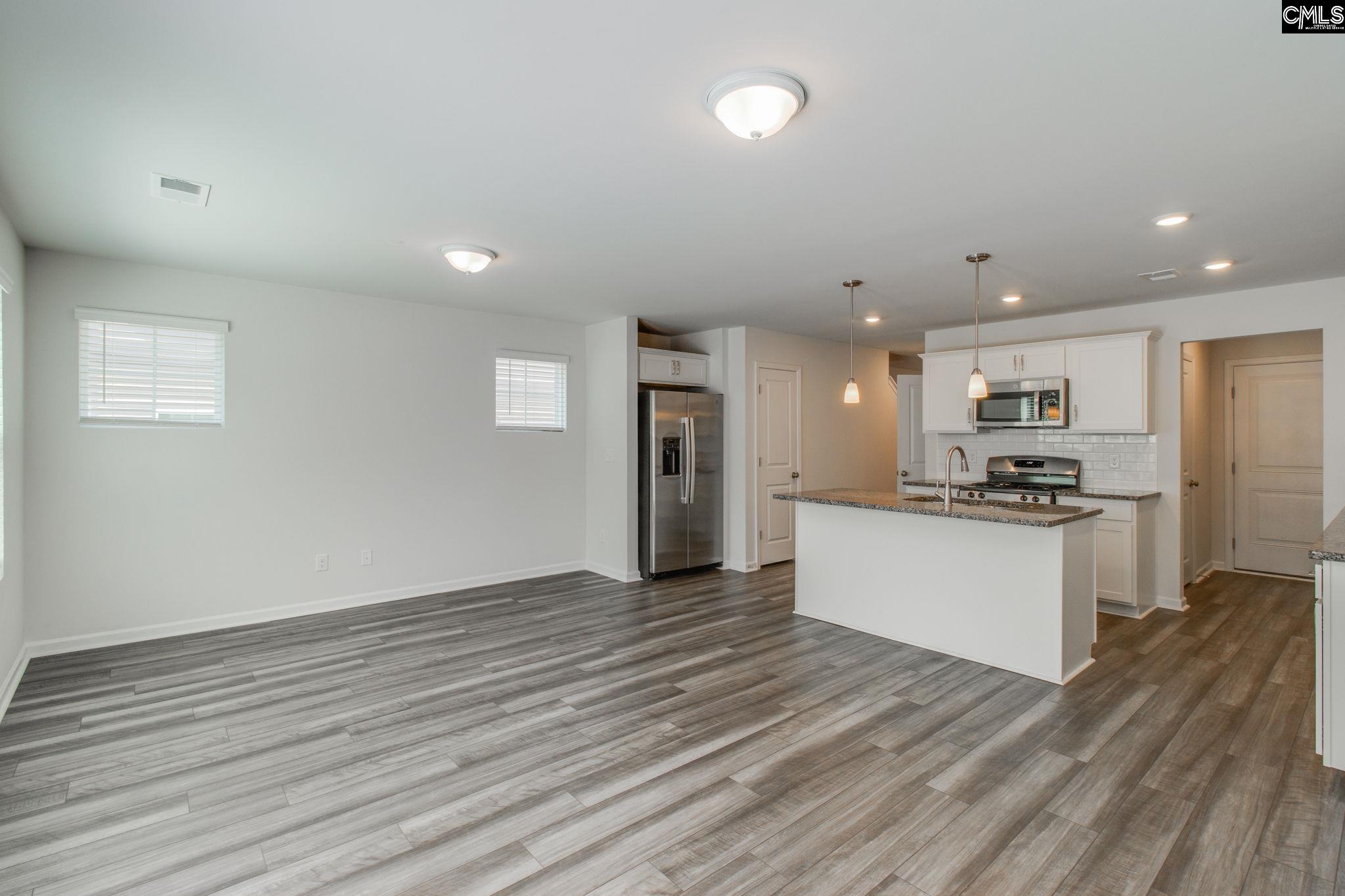 312 Reedmace Court Lexington, SC 29072 - Photo 8 of 29 a kitchen with stainless steel appliances granite countertop a refrigerator and a stove top oven