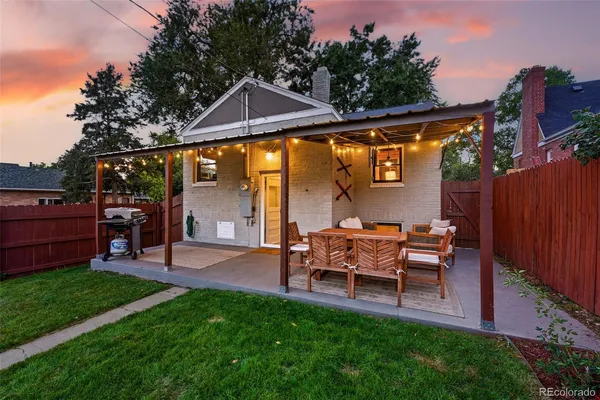 a view of a house with a yard and sitting area