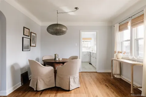 a living room with furniture a window and a chandelier