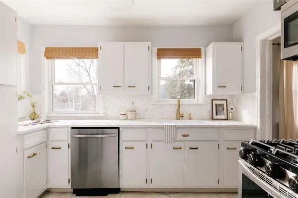 a kitchen with cabinets appliances and a window