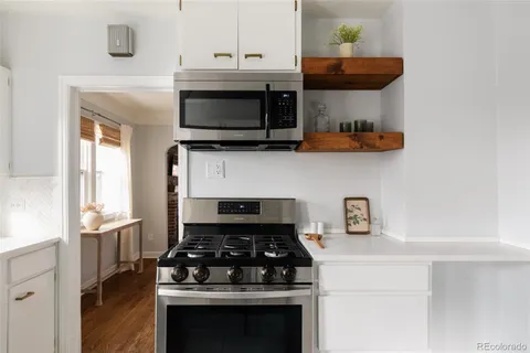 a kitchen with stainless steel appliances a stove a microwave and cabinets