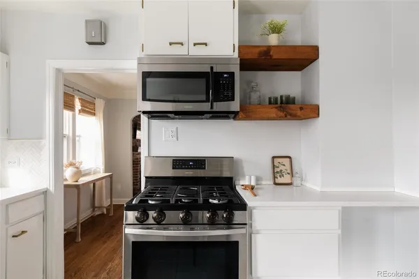 a kitchen with stainless steel appliances a stove a microwave and cabinets