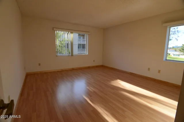 a view of a room with wooden floor and windows