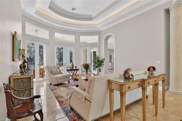 a living room with furniture a rug and white walls