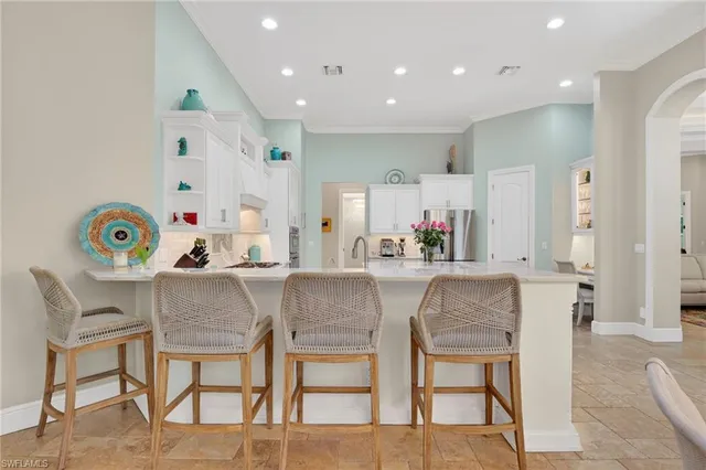 a dining room with kitchen island a dining table and chairs with wooden floor