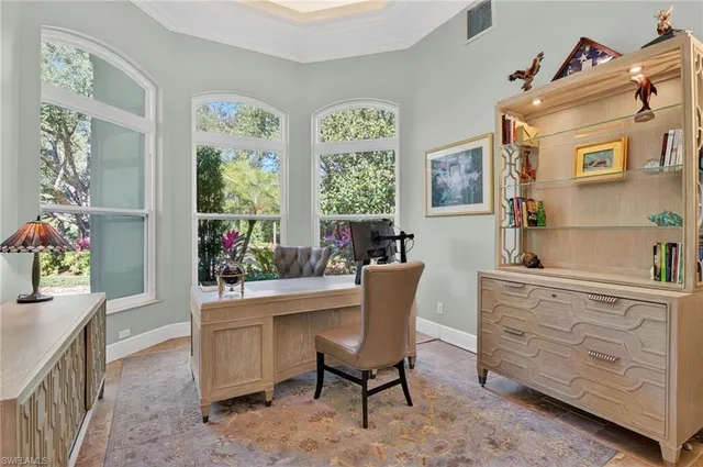 a view of a workspace with furniture and a window
