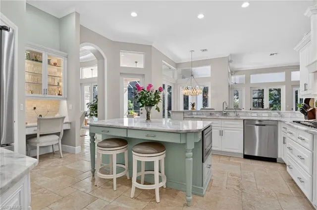 a kitchen with granite countertop cabinets a table and chairs in it