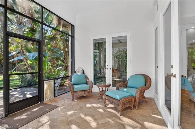 a view of a porch with chairs and backyard of the house