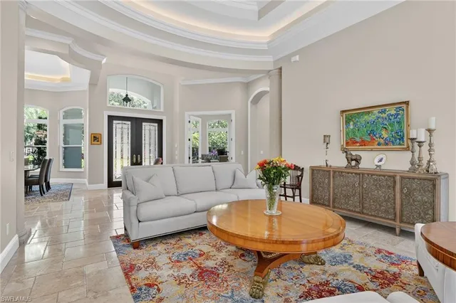 a living room with furniture and a dining table