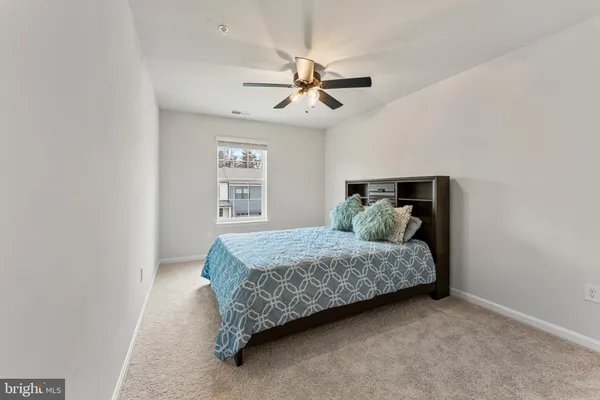 a bedroom with a bed and ceiling fan