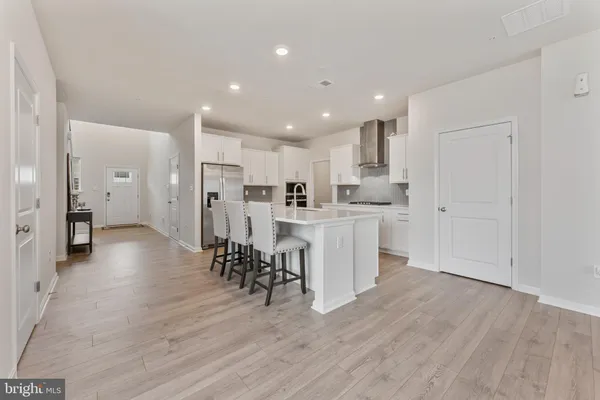 a kitchen with stainless steel appliances a refrigerator sink and cabinets