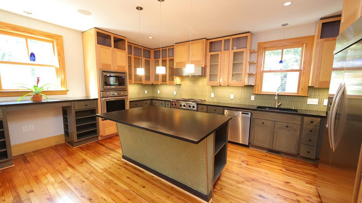 2308 Byrd Street Raleigh, NC 27608 - Photo 11 of 30 Gourmet Kitchen with fabulous refinished pine floors taken from the original attic. Premier stainless steel appliances such as Thermador & Bosch with granite counters & tile backsplash. Kitchen