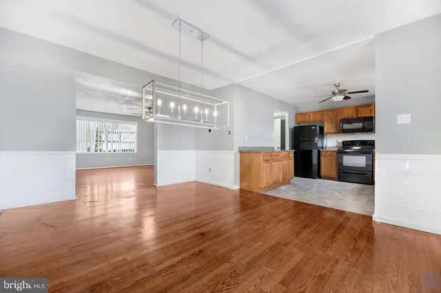 a view of a house with brick walls and a yard with plants