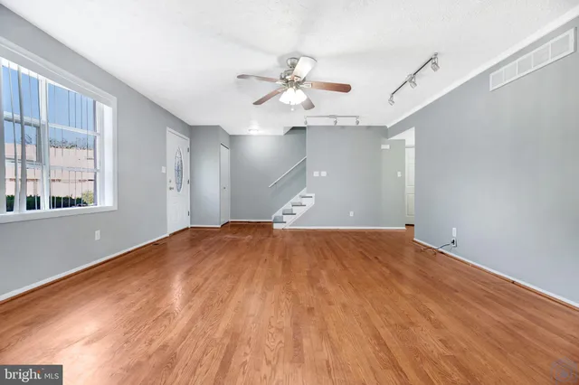 wooden floor in an empty room with a window