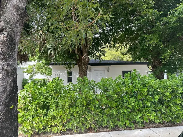 front view of a house with a tree