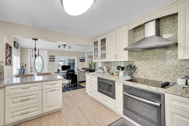 a kitchen with a stove oven and sink