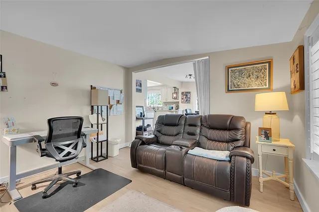a living room with furniture gym equipment and a window