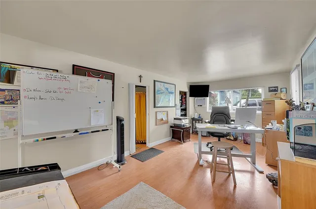 a workspace with furniture and a flat screen tv