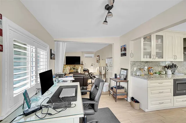 a view of a workspace with furniture and a window
