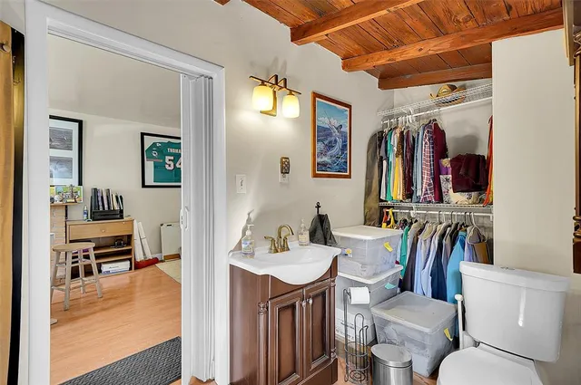 a bathroom with a sink a toilet and a mirror