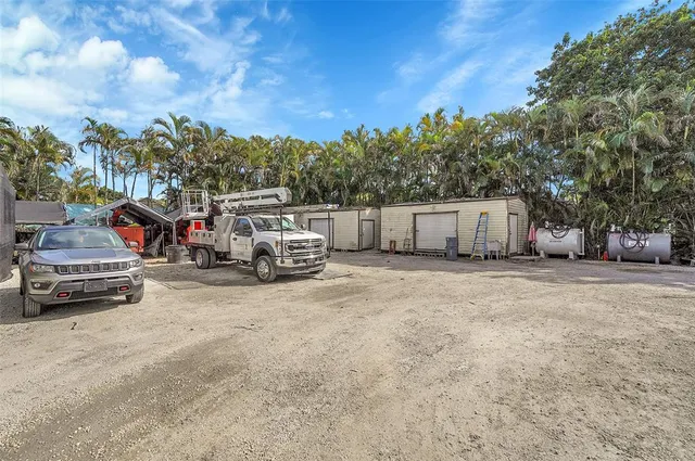 a view of a chairs and table in the backyard