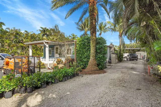 a couple of cars parked in front of a house