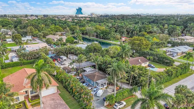 an aerial view of a house with a yard basket ball court and outdoor seating